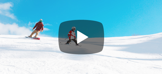 ゲレンデを滑走するスキーヤーとスノーボーダー
